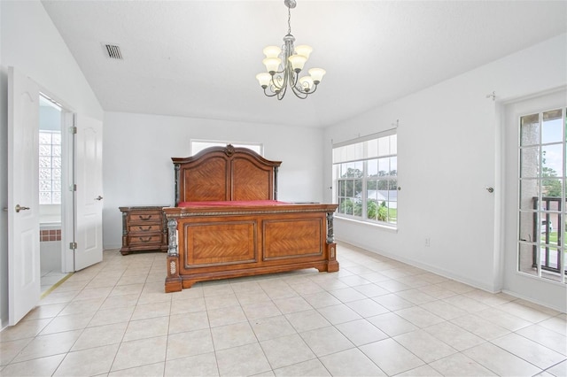 tiled bedroom featuring an inviting chandelier and vaulted ceiling