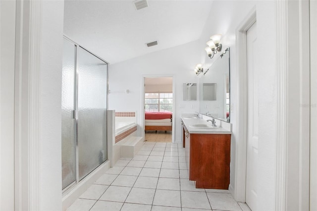 bathroom featuring vanity, tile patterned flooring, vaulted ceiling, and separate shower and tub