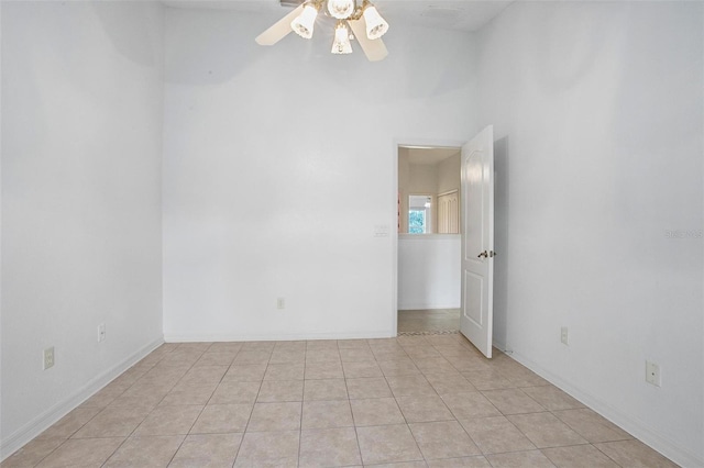 unfurnished room with light tile patterned floors and ceiling fan