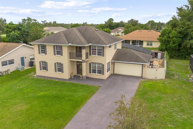 view of front of home featuring a balcony and a front yard