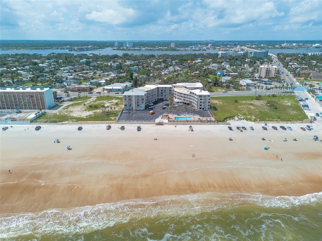 birds eye view of property featuring a beach view and a water view