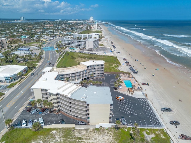 bird's eye view with a water view and a beach view