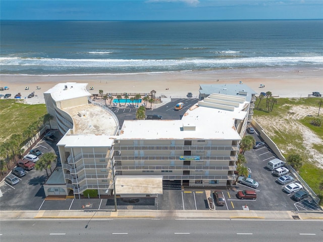 drone / aerial view featuring a water view and a view of the beach