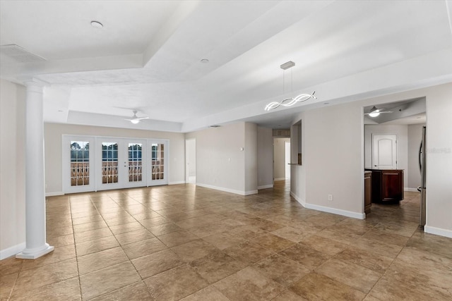 spare room featuring ceiling fan, french doors, and a tray ceiling