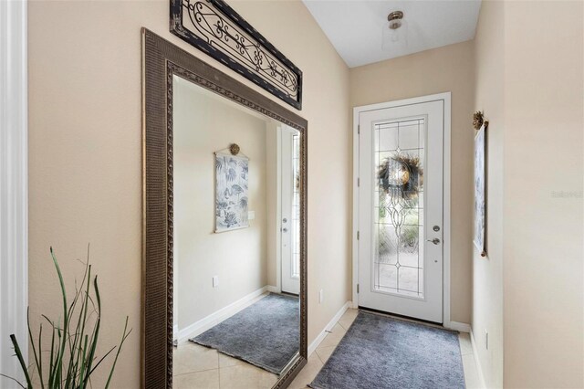 foyer entrance with light tile patterned floors and plenty of natural light