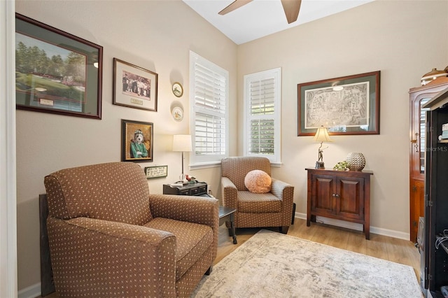 living area featuring light hardwood / wood-style flooring and ceiling fan