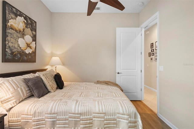 bedroom with light wood-type flooring and ceiling fan