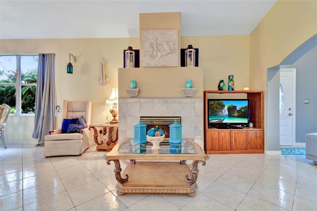 tiled living room with a tiled fireplace