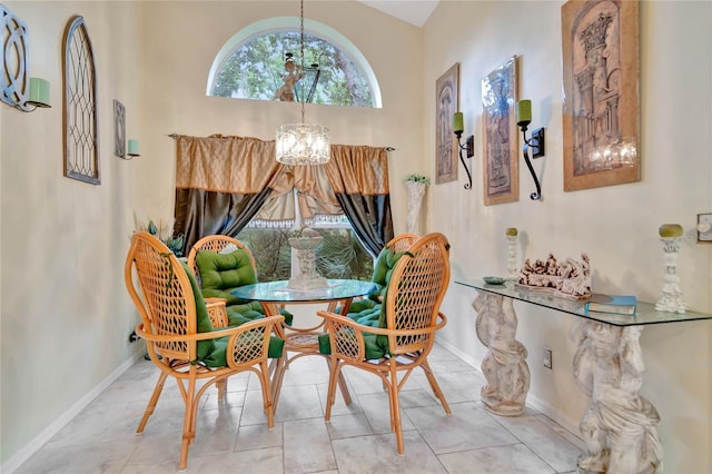 tiled dining room with lofted ceiling and an inviting chandelier