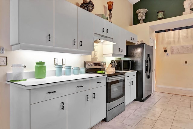 kitchen featuring white cabinets, appliances with stainless steel finishes, and light tile patterned flooring