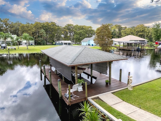 view of dock featuring a water view and a yard