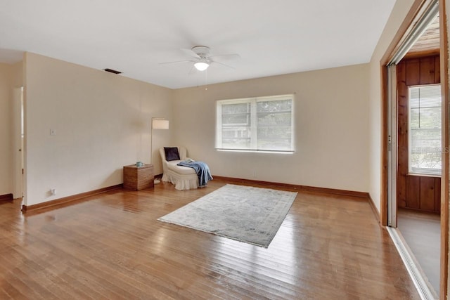 sitting room with ceiling fan and light hardwood / wood-style floors