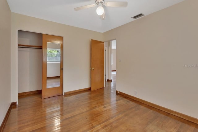 unfurnished bedroom with ceiling fan, light hardwood / wood-style flooring, and a closet