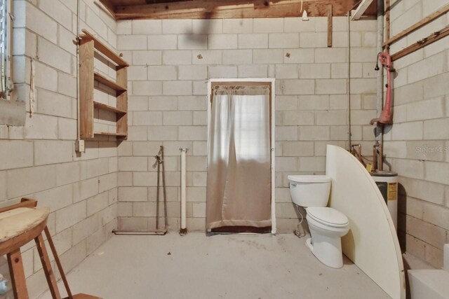 bathroom featuring concrete flooring and toilet