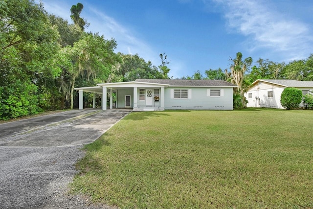 ranch-style house with a front lawn, a carport, and a porch