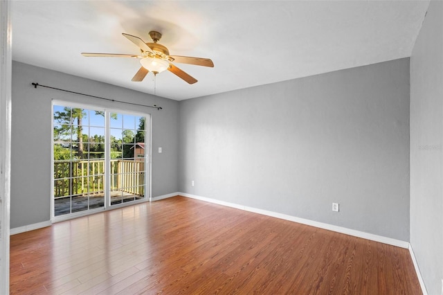 empty room with hardwood / wood-style flooring and ceiling fan