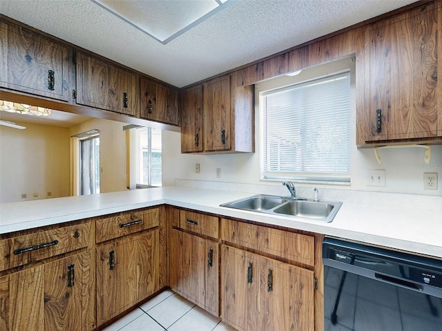 kitchen with light tile patterned flooring, kitchen peninsula, dishwasher, a textured ceiling, and sink