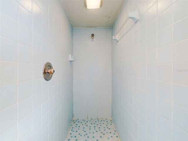 bathroom with tiled shower