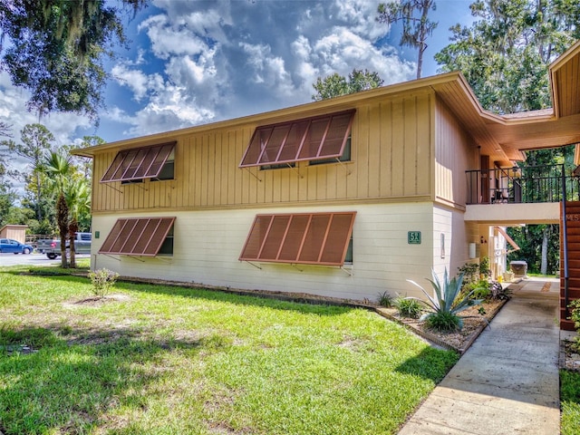 view of side of property with a yard