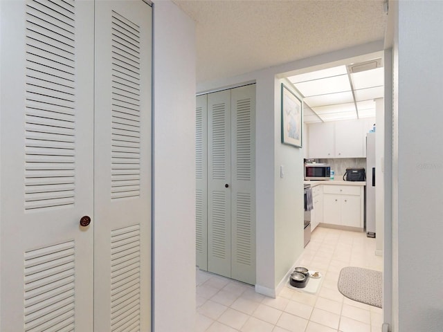 hallway with light tile patterned floors