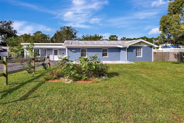 back of property featuring a yard and a patio