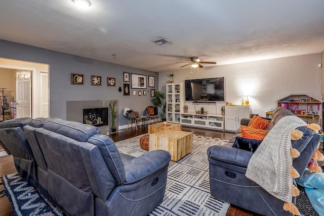 living room with ceiling fan and hardwood / wood-style flooring