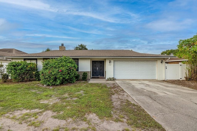 single story home with a garage and a front yard