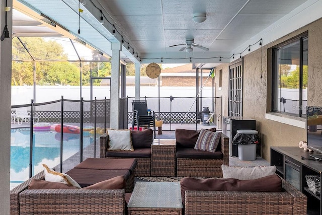 interior space with ceiling fan