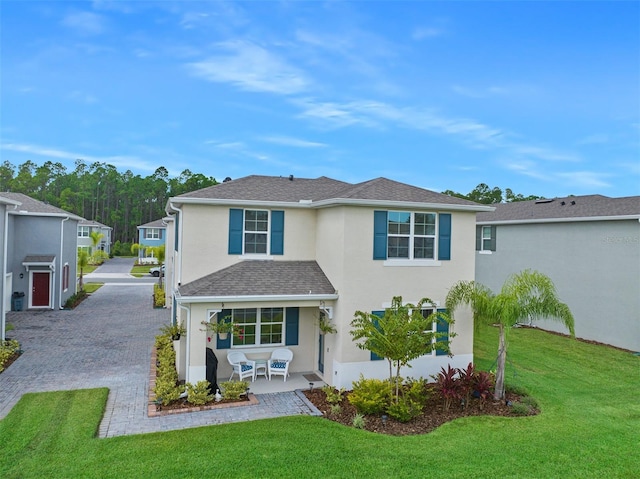 rear view of property featuring a lawn