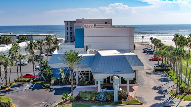 birds eye view of property featuring a beach view and a water view