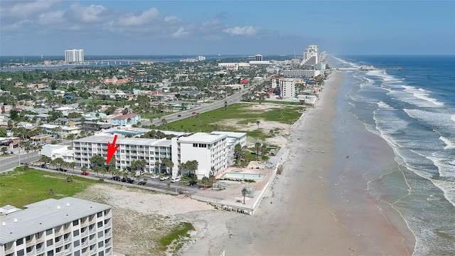 birds eye view of property with a view of the beach and a water view