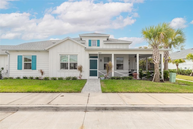 view of front of property with a front yard and covered porch