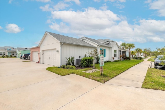 single story home featuring a garage, central AC unit, and a front lawn