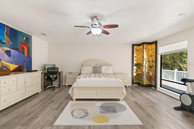 bedroom with access to exterior, ceiling fan, a textured ceiling, and light wood-type flooring