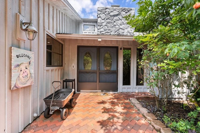 view of exterior entry with a chimney