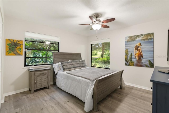 bedroom with ceiling fan and light wood-type flooring