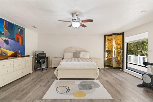 bedroom with access to outside, ceiling fan, light wood-style flooring, and a textured ceiling