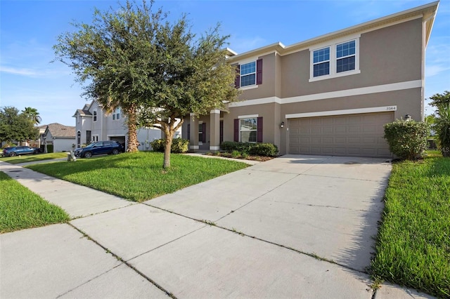 view of front of property with a garage and a front lawn