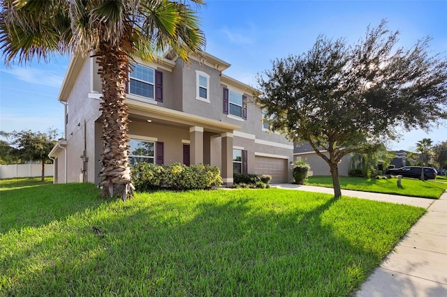 view of front of home featuring a garage and a front lawn