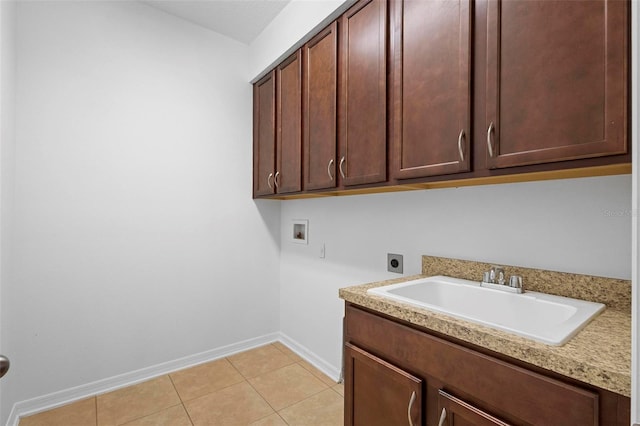 washroom featuring hookup for an electric dryer, cabinets, sink, light tile patterned flooring, and hookup for a washing machine