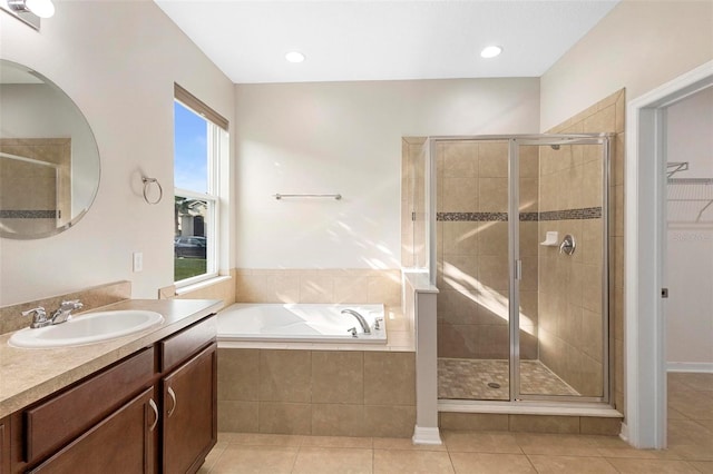 bathroom with vanity, shower with separate bathtub, and tile patterned flooring