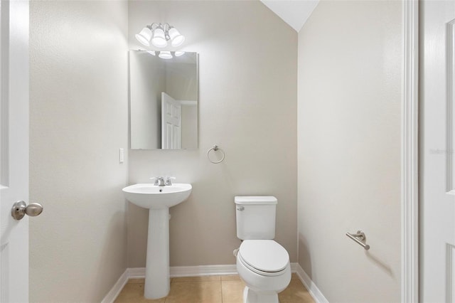 bathroom with sink, tile patterned flooring, toilet, and lofted ceiling