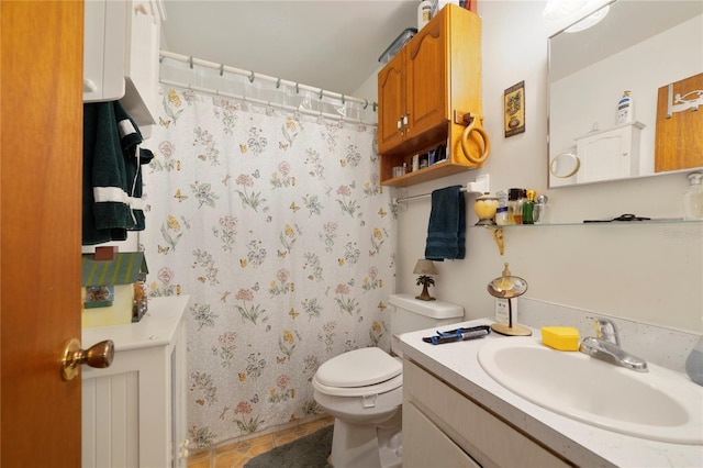 bathroom featuring tile patterned flooring, a shower with curtain, vanity, and toilet