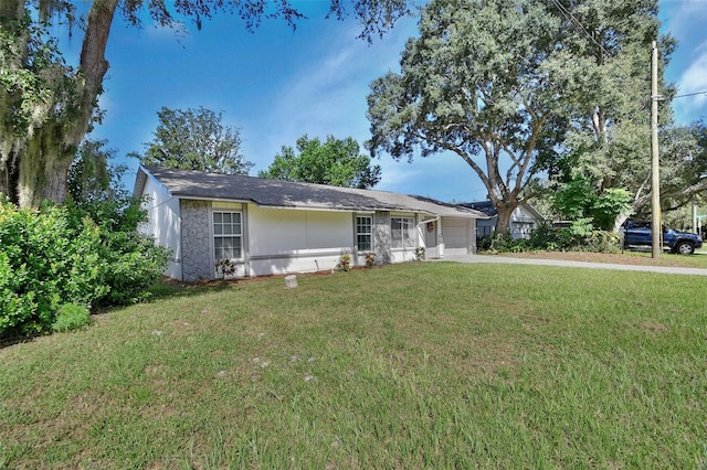 ranch-style house with a front yard and a garage