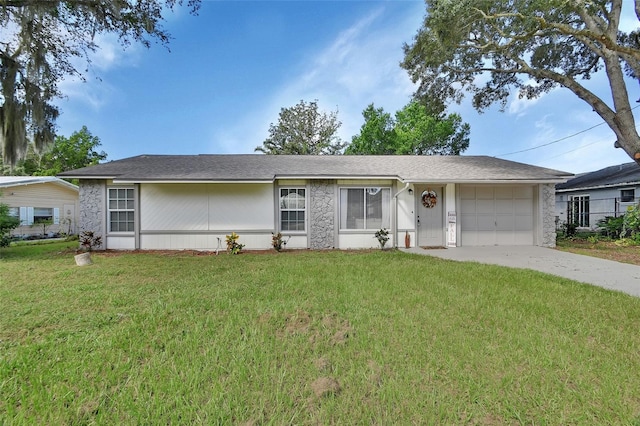 ranch-style house with a garage and a front lawn