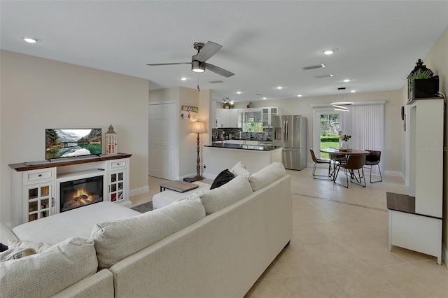 tiled living room with ceiling fan