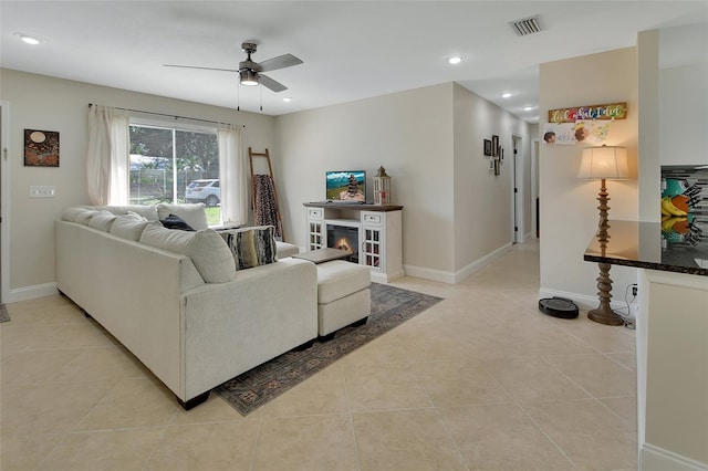 tiled living room with ceiling fan