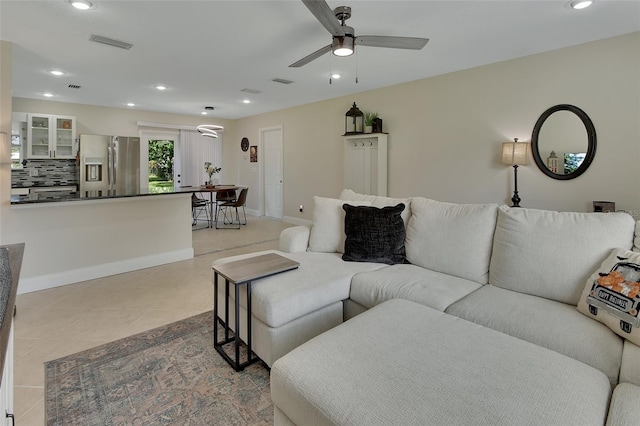 tiled living room featuring ceiling fan