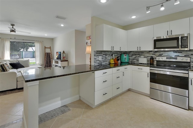 kitchen featuring appliances with stainless steel finishes, kitchen peninsula, ceiling fan, and white cabinets