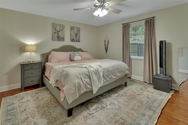 bedroom with light hardwood / wood-style floors and ceiling fan